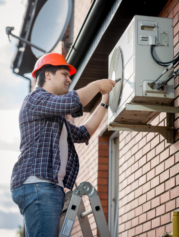 Professional technician installing outdoor AC unit
